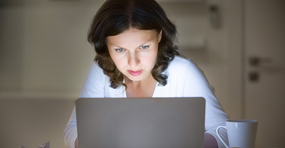 Woman works on a laptop in her home office